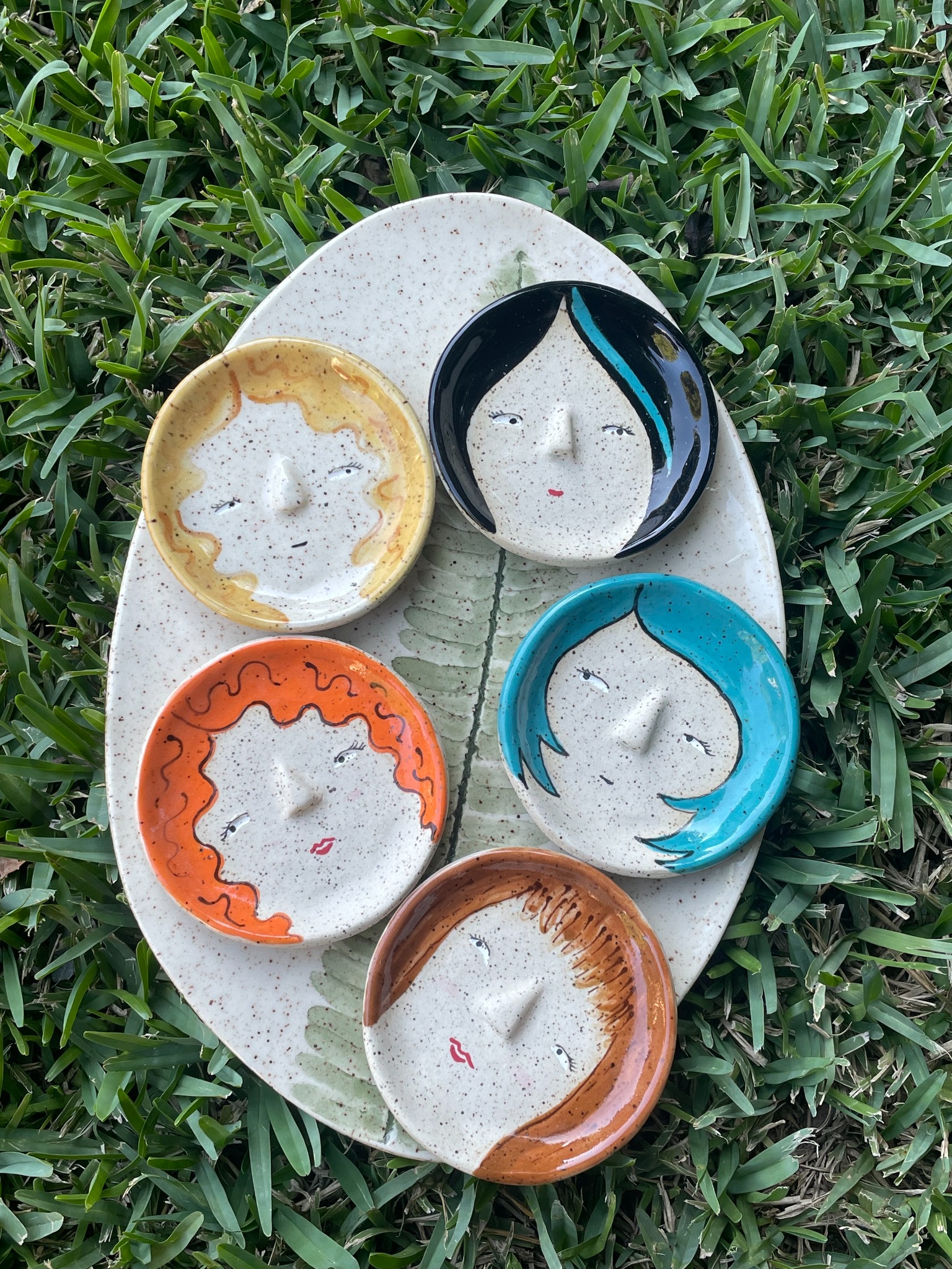 Handmade ceramic face dishes in bright colors